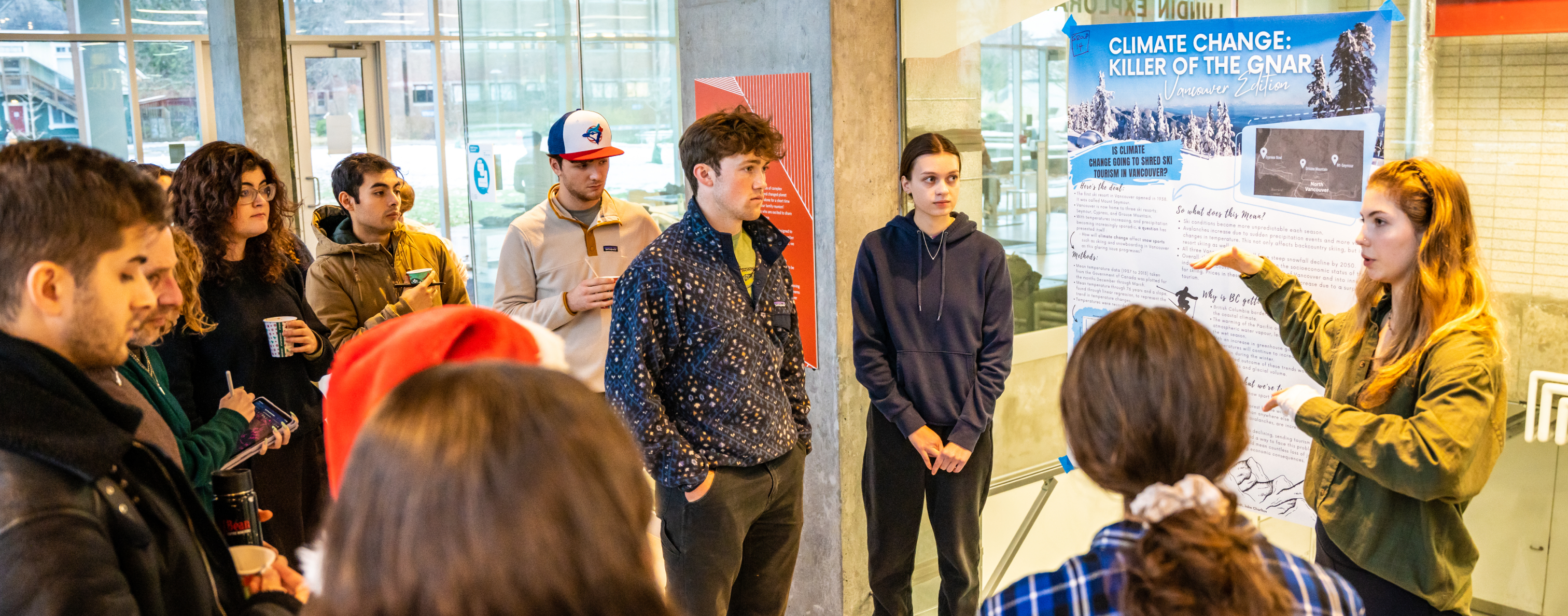 Students gathered around a poster and presenter